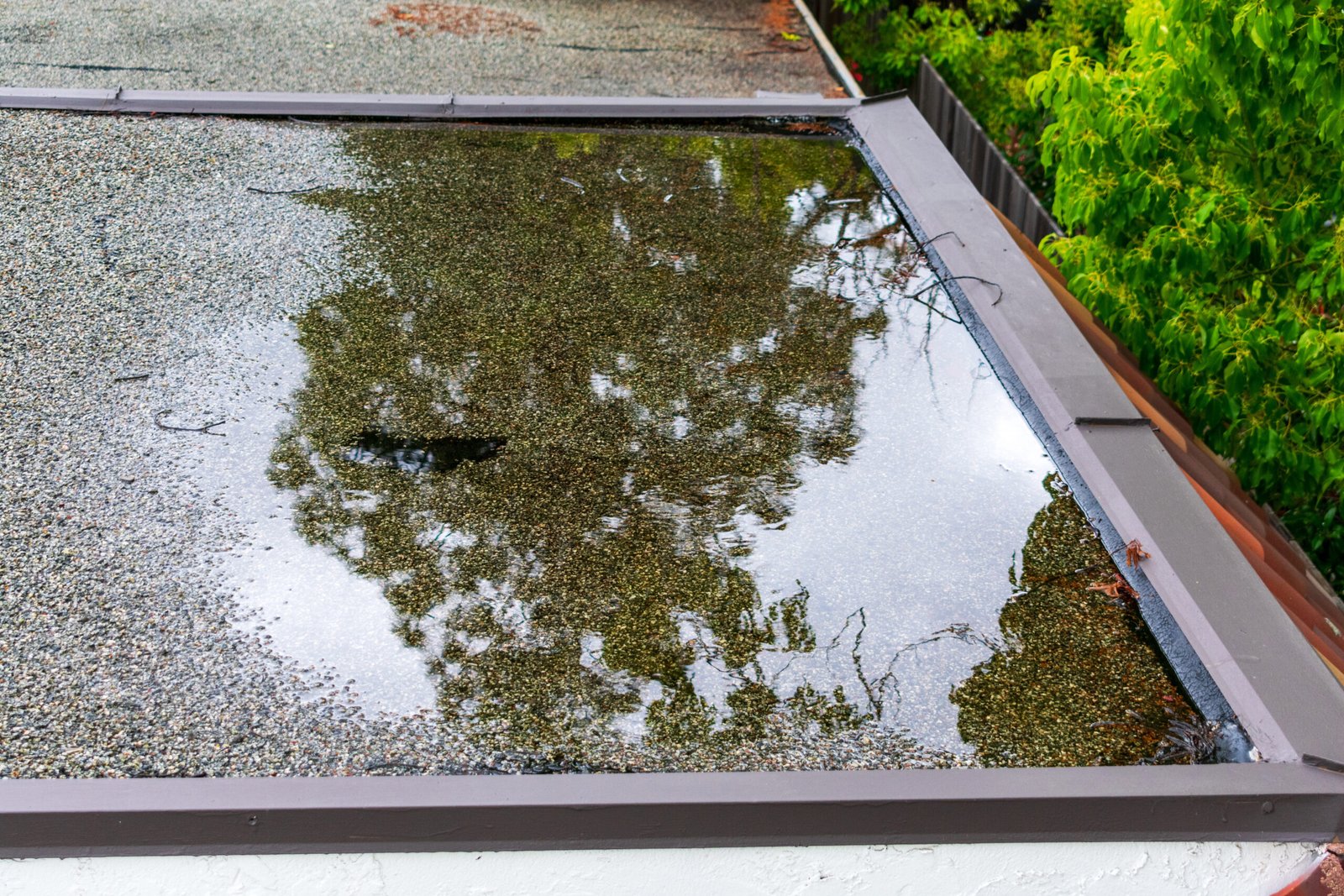 durham-roof-leak-repair Ponding standing water on a flat roof in Durham after heavy rain can start to cause leaks