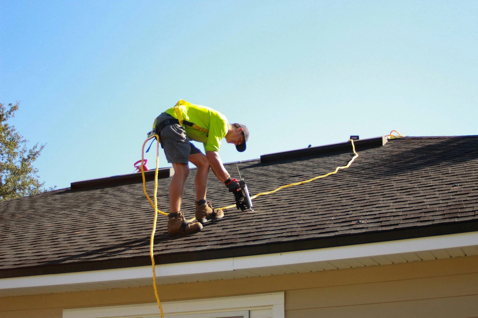 durham-roof- leak-repair Roofer temporarily sealing leak on house roof top in Durham, On.